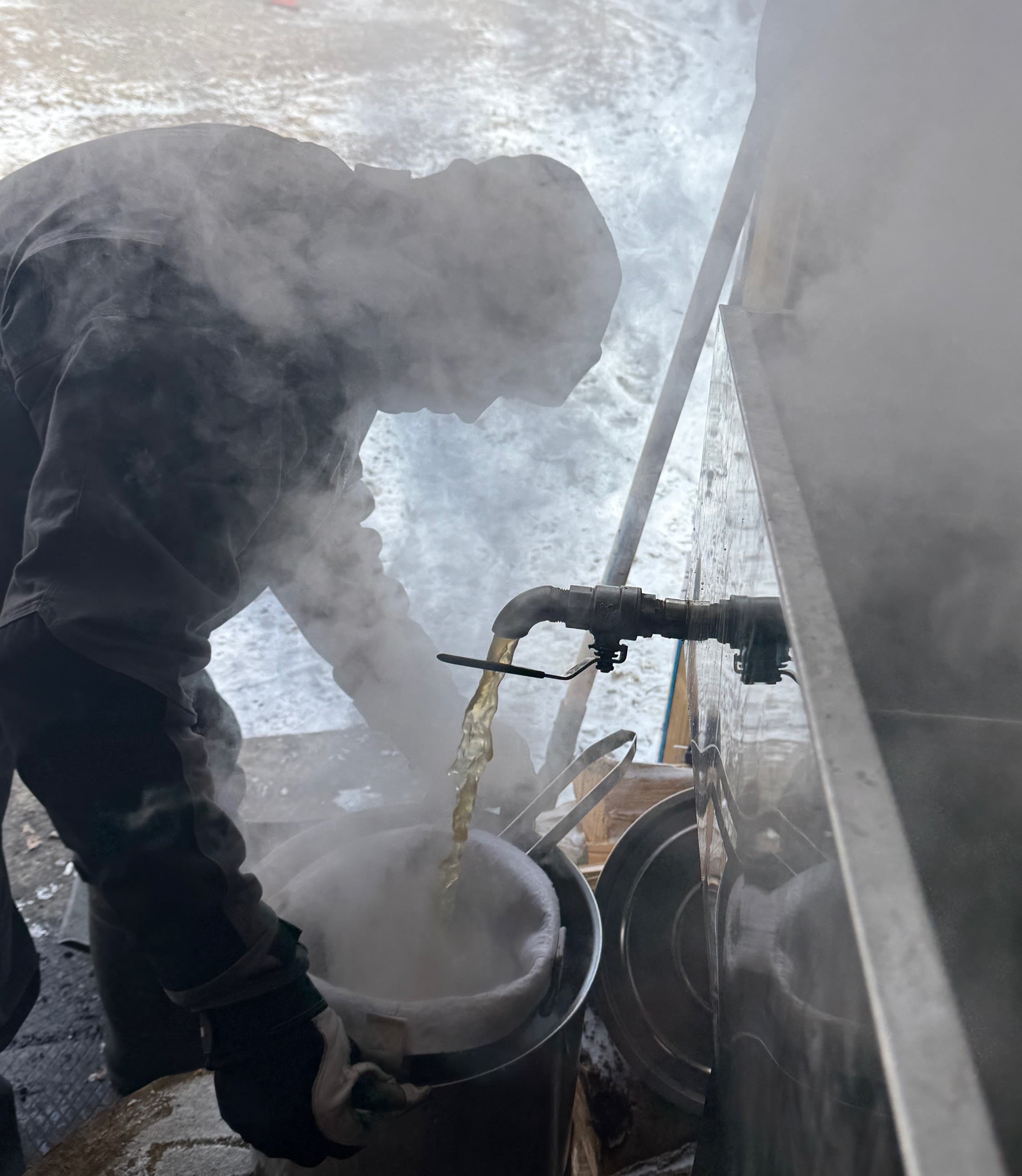 Jamie working with hot sap during maple syrup season